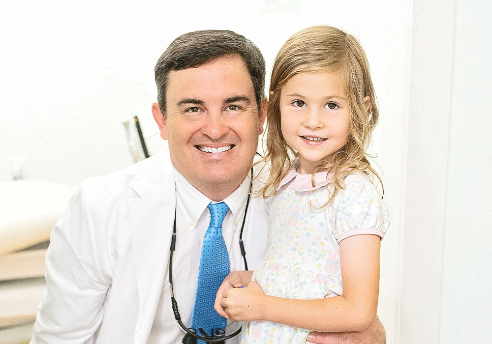 Dr. Green smiling with child