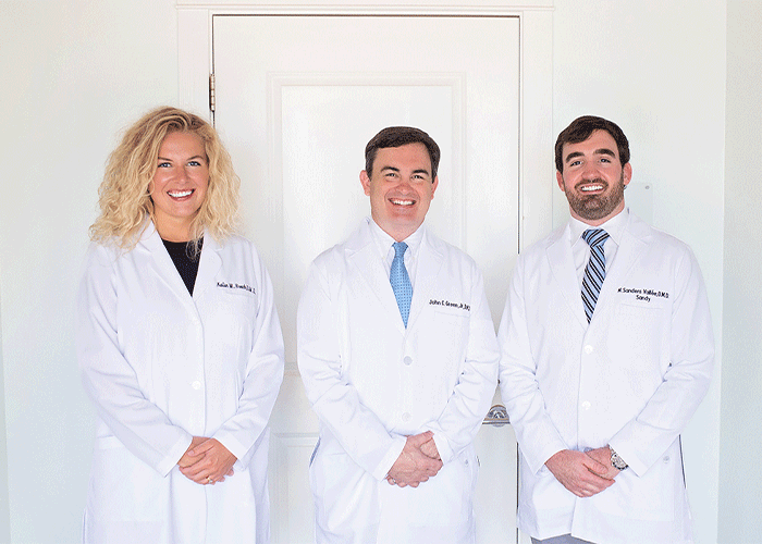 From left to right, Drs. Roach, Green, and Vallee pose for a group photo at Fairhope Dental Associates in Fairhope, AL.