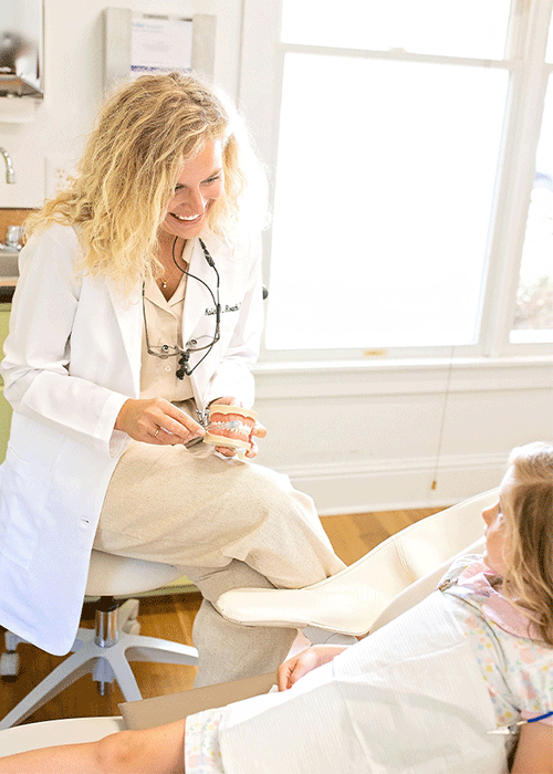 Dr. Kalin Roach talking with a pediatric patient at Fairhope Dental Associates in Fairhope, AL.