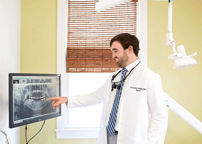 Dr. Sandy Vallee pointing to X-rays at Fairhope Dental Associates in Fairhope, AL.